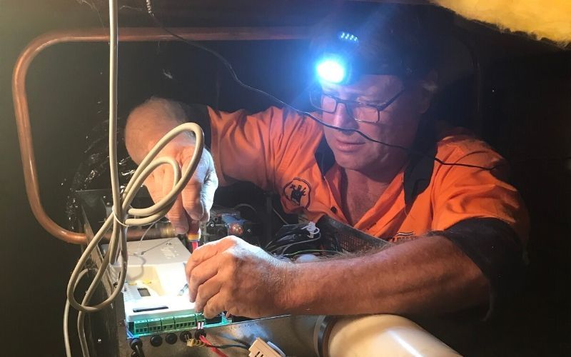 Service technician repairing a gas heater